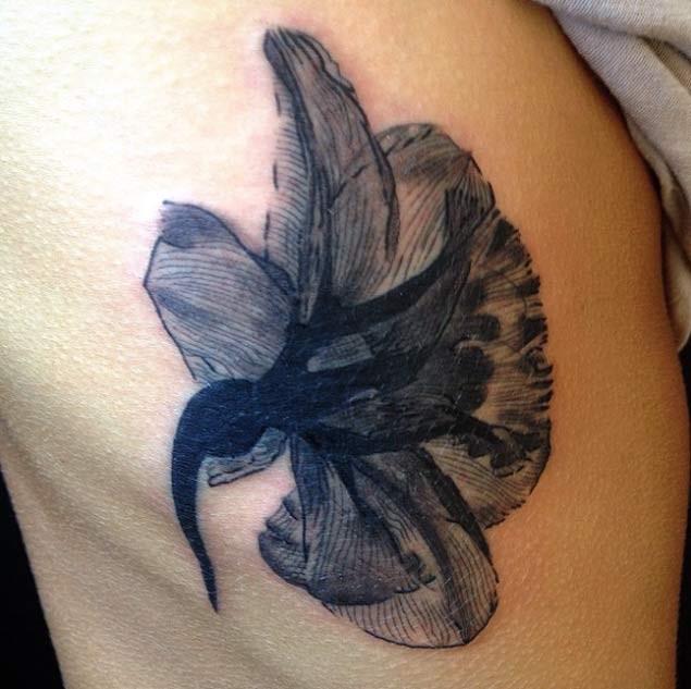 Unique vintage style black ink flower tattoo on side