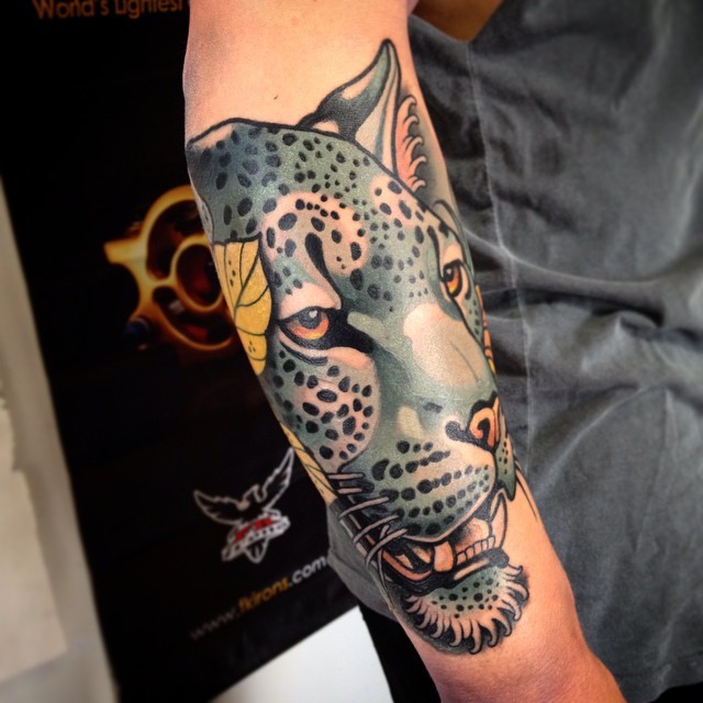 New school style colored arm tattoo of colored leopard with feather