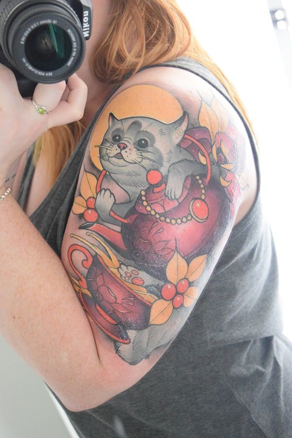 Illustrative style colored shoulder tattoo of lucky cat with flowers and cup