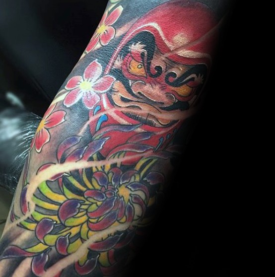New school style colored arm tattoo of daruma doll with large chrysanthemum