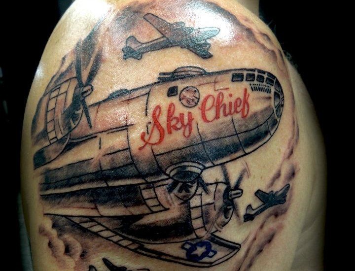 Illustrative style colored shoulder tattoo of WW2 bomber plane