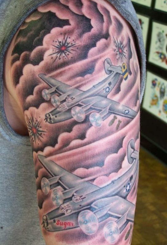 Illustrative style colored shoulder tattoo of large American bomber planes