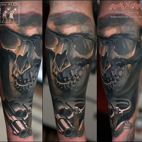 New school style colored forearm tattoo of human skull with pistol and bullets