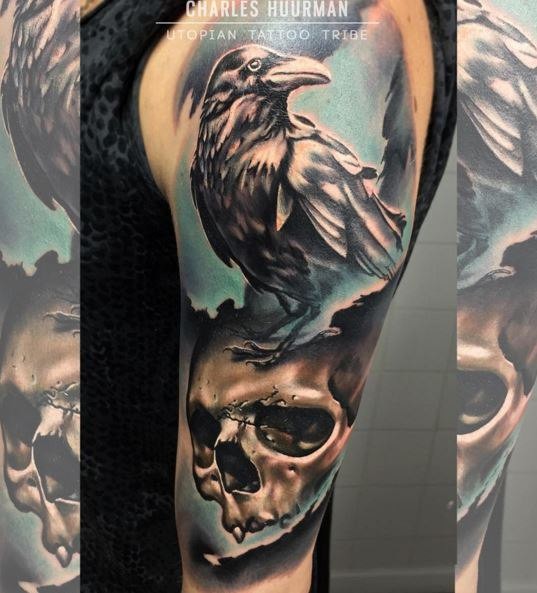 New school style colored shoulder tattoo of crow with human skull