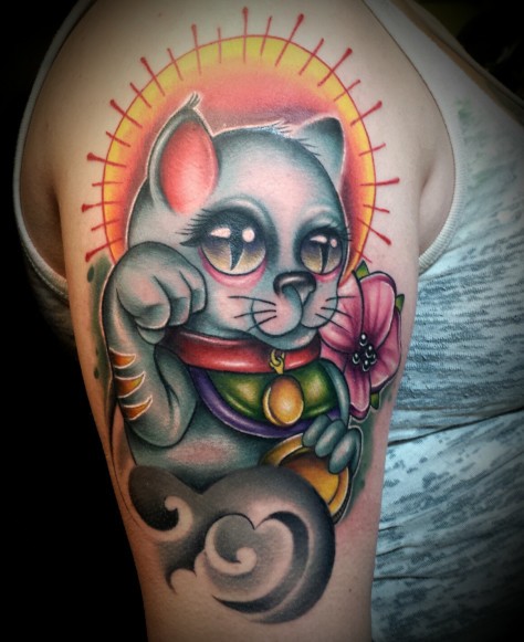New school style colored shoulder tattoo of maneki neko japanese lucky cat with sun and flowers