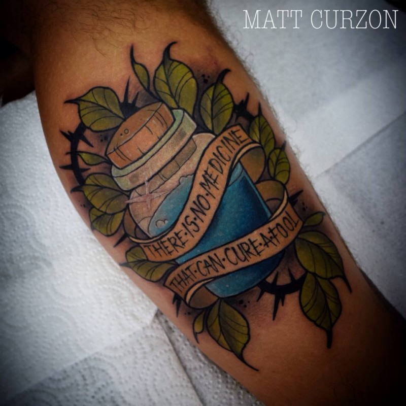 New school style colored leg tattoo of small potion with lettering and leaves