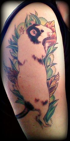 Illustrative style colored shoulder tattoo of small rat with flowers