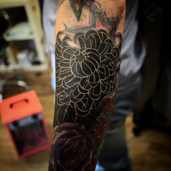 Unusual colored big black chrysanthemum flower tattoo on arm