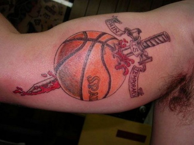 Unusual combined and colored biceps tattoo of basketball with samurai sword and lettering