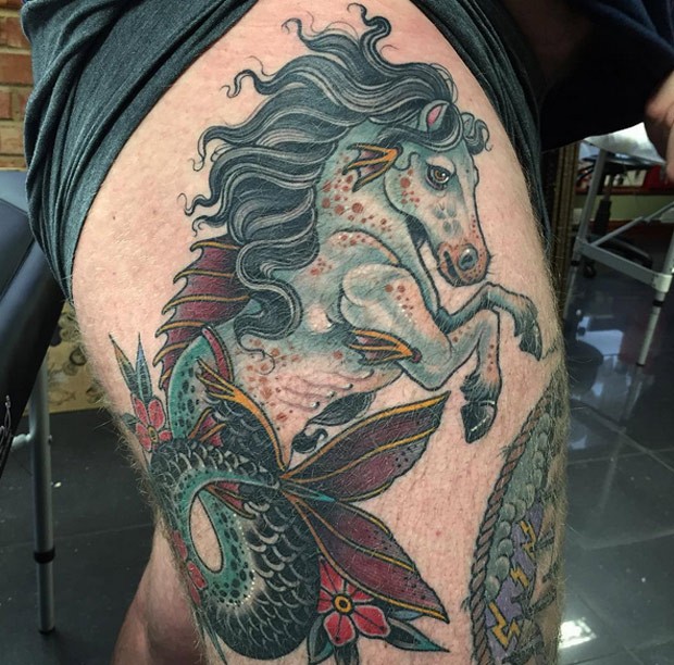 Unusual combined and colored thigh tattoo of horse with fish tail