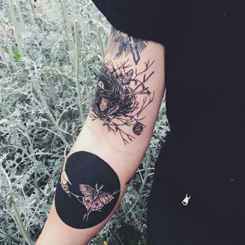 Unusual combined black and white birds nest tattoo on sleeve with night butterfly