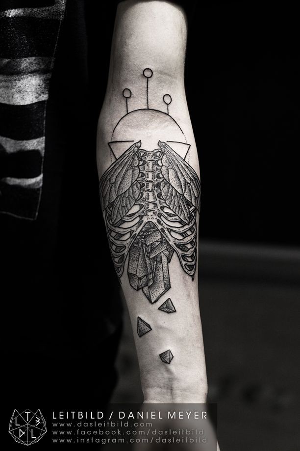 Unusual combined black and white skeleton with wings and broken stone tattoo on arm