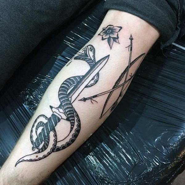 Unusual combined black and white snake with bow and sword tattoo on arm