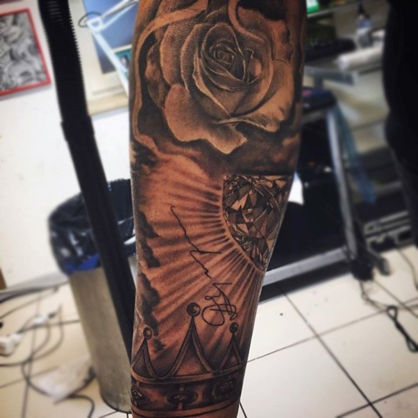 Unusual combined black ink rose with diamond and crown tattoo on arm