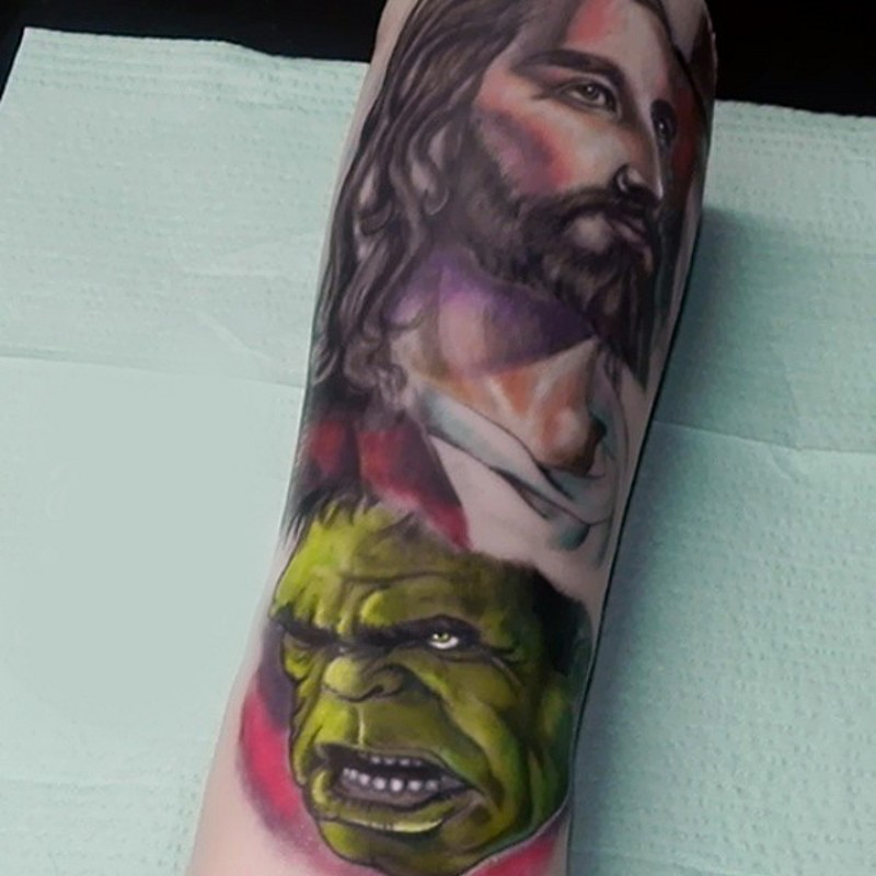 Unusual combined colored Jesus face tattoo on forearm combined with Hulk face