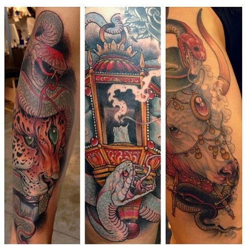 Unusual combined colorful detailed antic street lighter with snakes and cow tattoo on sleeve