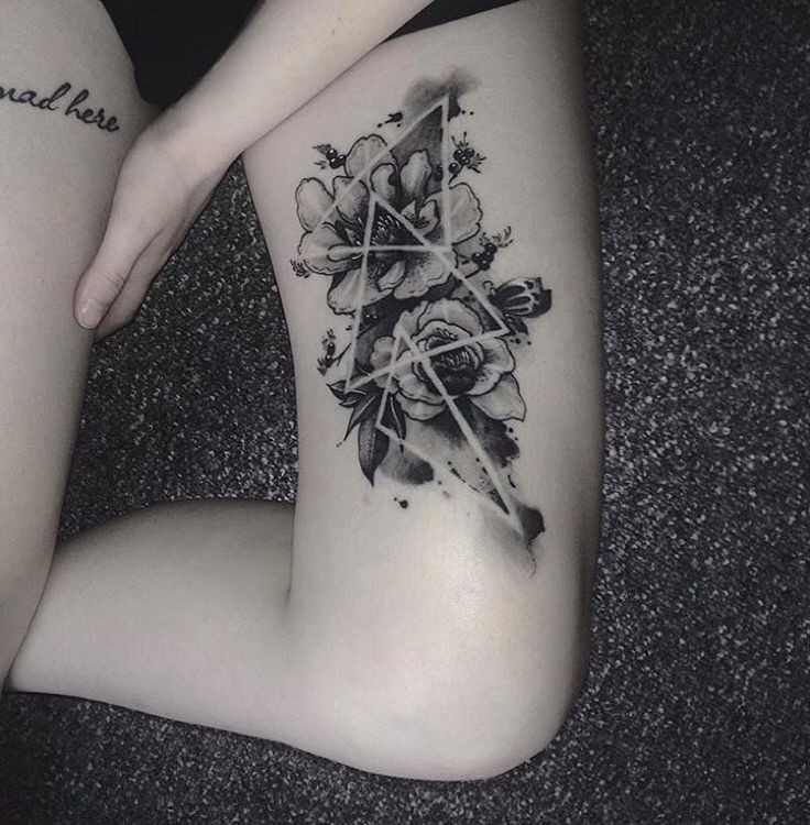 Unusual combined dotwork style thigh tattoo of flowers with triangles