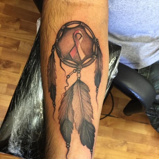 Unusual designed and colored forearm tattoo of ancient dream catcher