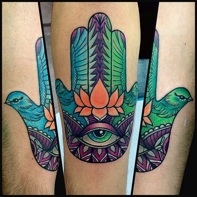 Unusual designed and colored Hamsa hand tattoo combined with birds