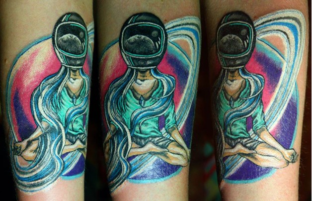 Unusual designed and colored meditating woman in helmet tattoo
