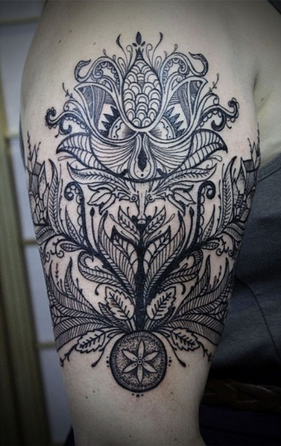 Unusual designed black and white shoulder tattoo of various floral ornaments