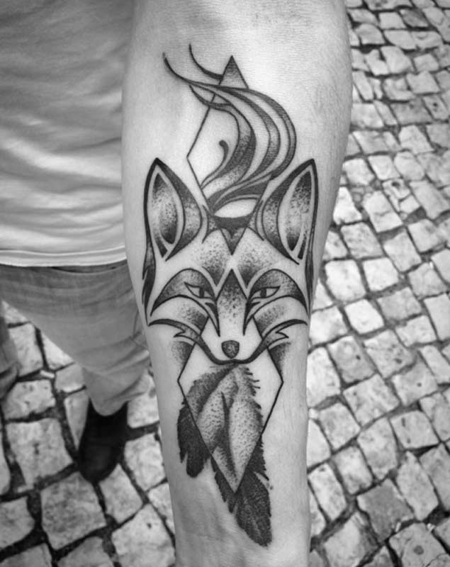 Unusual designed black ink mystic fox tattoo on forearm stylized with geometrical figures and feather