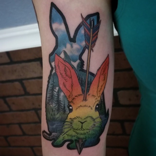 Unusual designed colorful forearm tattoo of bunny with arrow in head