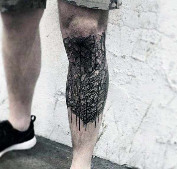 Unusual designed little black and white mystic tattoo on leg