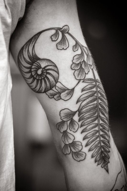 Unusual flower tattoo on arm by Kirsten