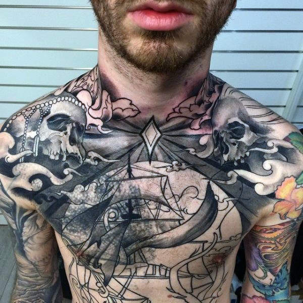 Unusual looking black ink whole chest tattoo of skulls with ship
