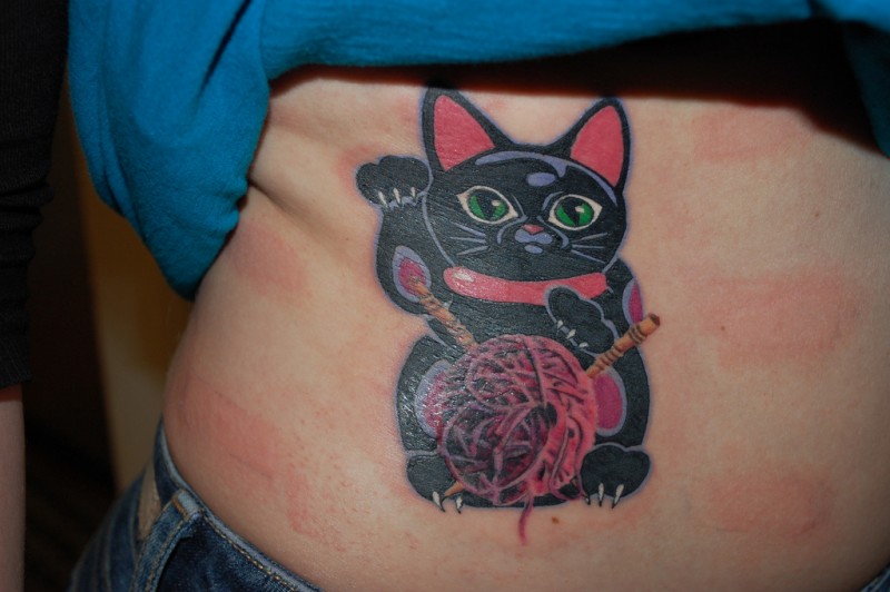 Unusual looking colored belly tattoo of maneki neko japanese lucky cat with needles