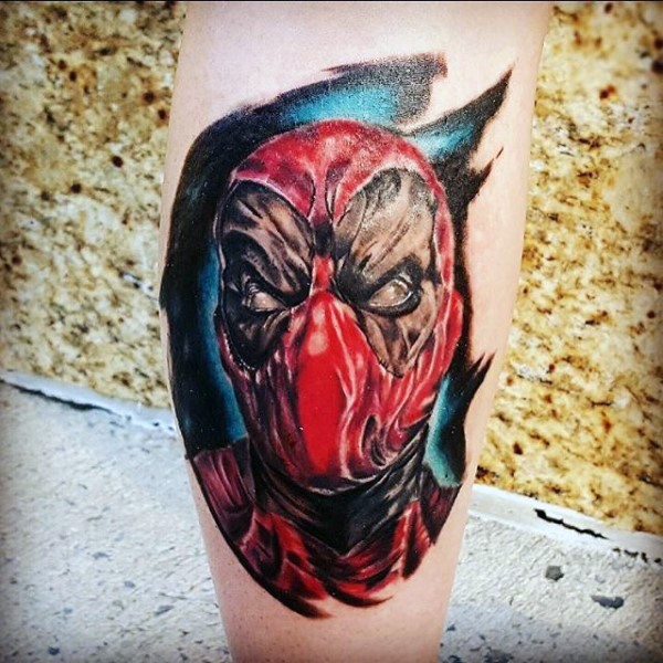 Unusual looking colored leg tattoo of big Deadpool face