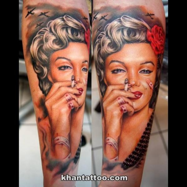 Unusual looking colored wounded smoking woman portrait tattoo on forearm combined with military planes