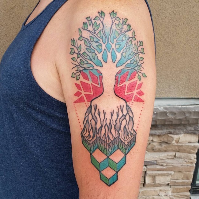 Unusual multicolored shoulder tattoo of tree silhouette with various geometrical figures