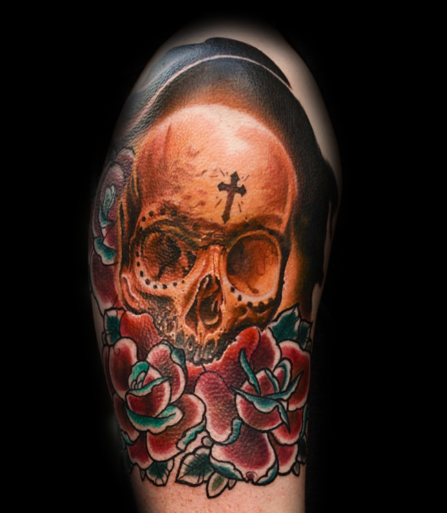 Unusual multicolored skull tattoo on shoulder combined with old school flowers