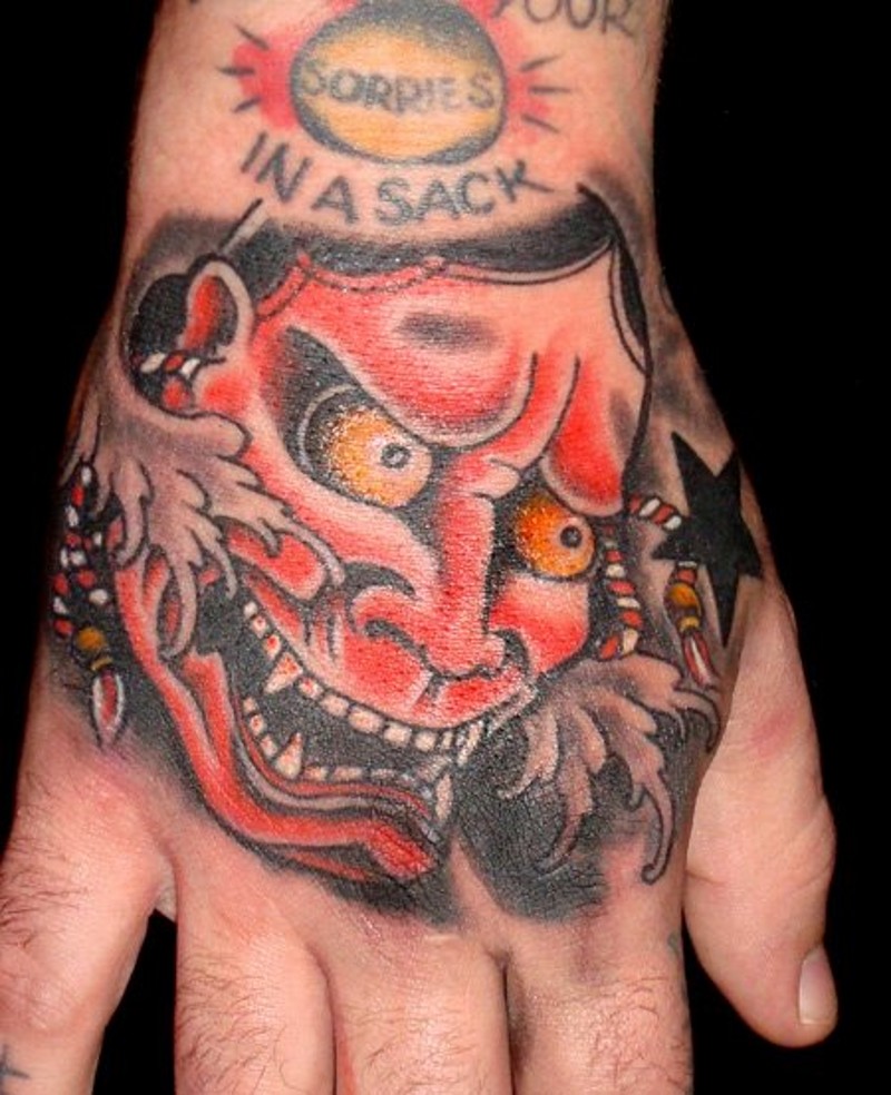 UOld school Asian traditional homemade painted colored arm tattoo of demonic face and stars
