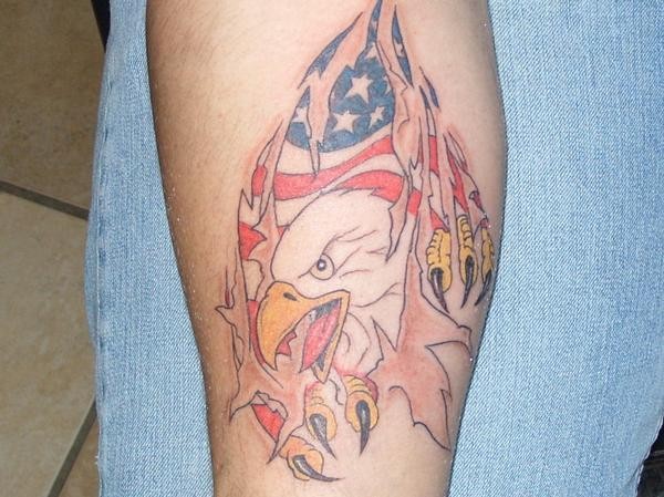 Usa flag and eagle under skin rip tattoo on forearm