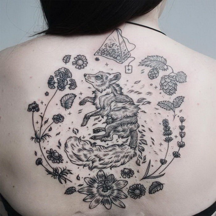 Usual black ink back tattoo of fox with plant and tea bag