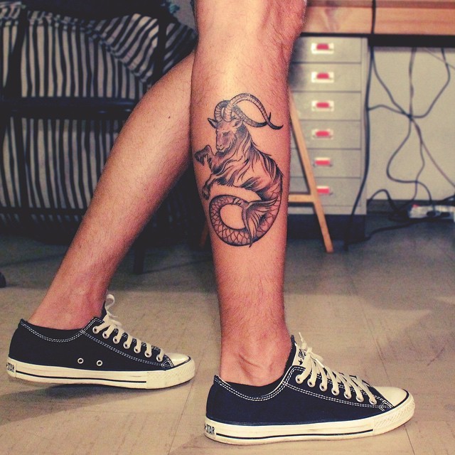 Usual black ink detailed Capricorn tattoo on leg muscle