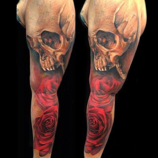Usual combined red rose tattoo on sleeve with human skull