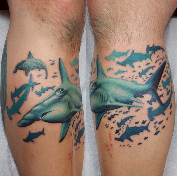 Usual designed and colored hammerhead sharks tattoo on leg