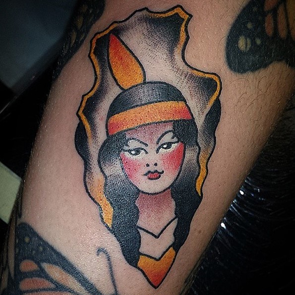 Usual old school antic arrow head stylized with Indian woman tattoo