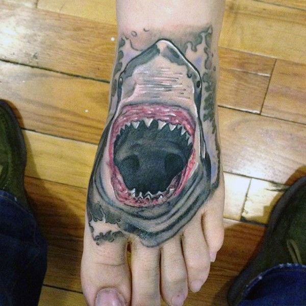 Usual painted and colored evil shark head tattoo on foot