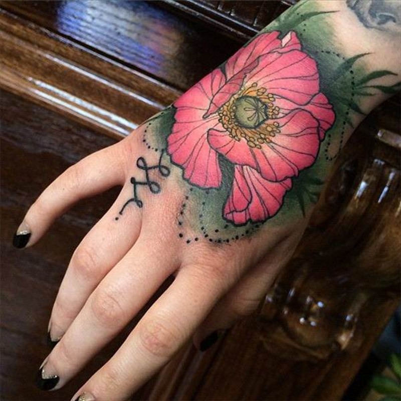 Usual painted pink colored natural looking flower tattoo on hand
