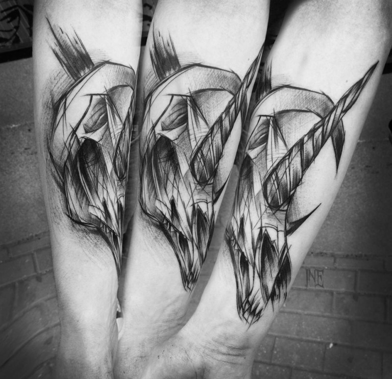 Usual sketch style black ink forearm tattoo by Inez Janiak of unicorn skull