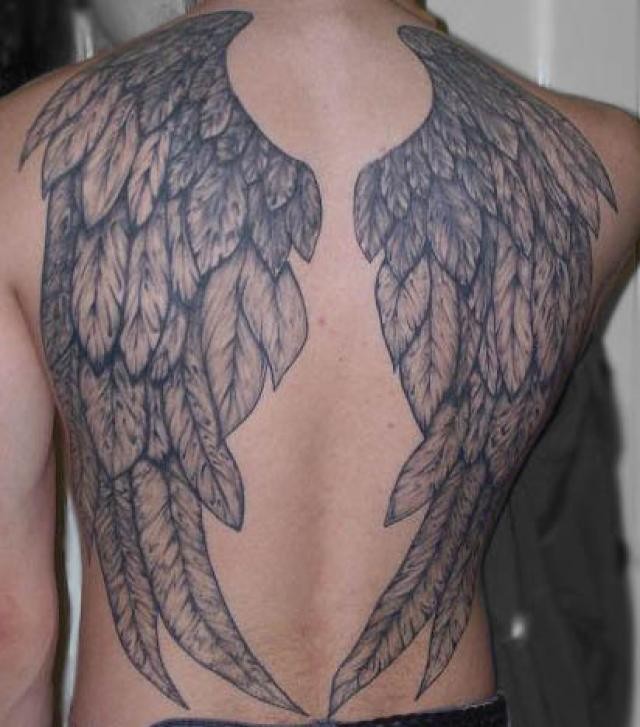 Usual style painted massive black and white wings tattoo on back