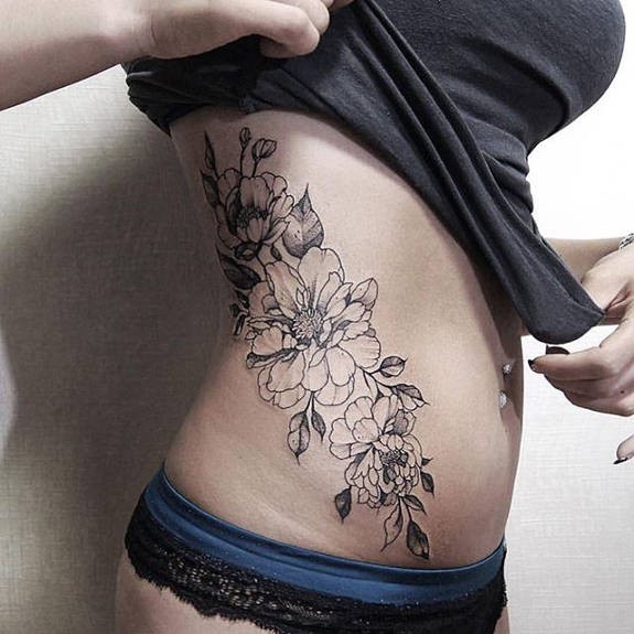 Usual Zihwa style black ink waist tattoo of wildflowers