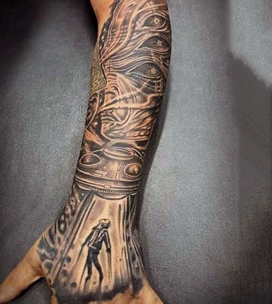 Very awesome painted black ink detailed alien ship stealing human tattoo on arm