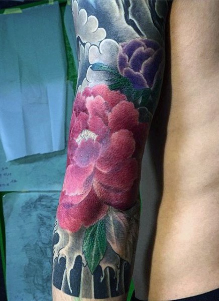 Very beautiful colored big flowers tattoo on sleeve
