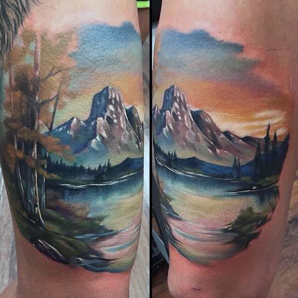 Very beautiful multicolored mountain lake tattoo on arm